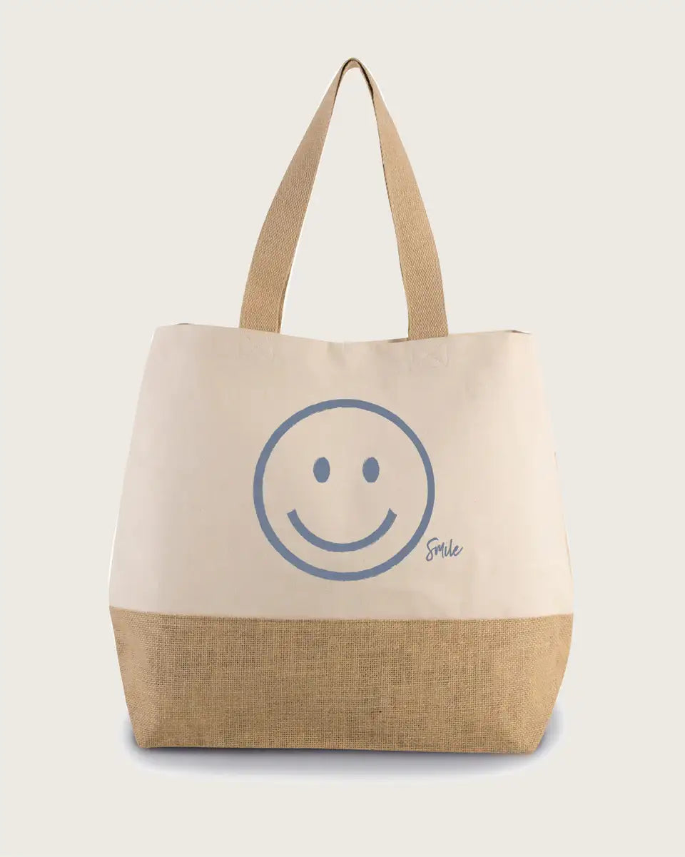 Naturfarbene Baumwoll-Jute-Shopper Tasche mit Smiley-Motiv und breiten Henkeln.