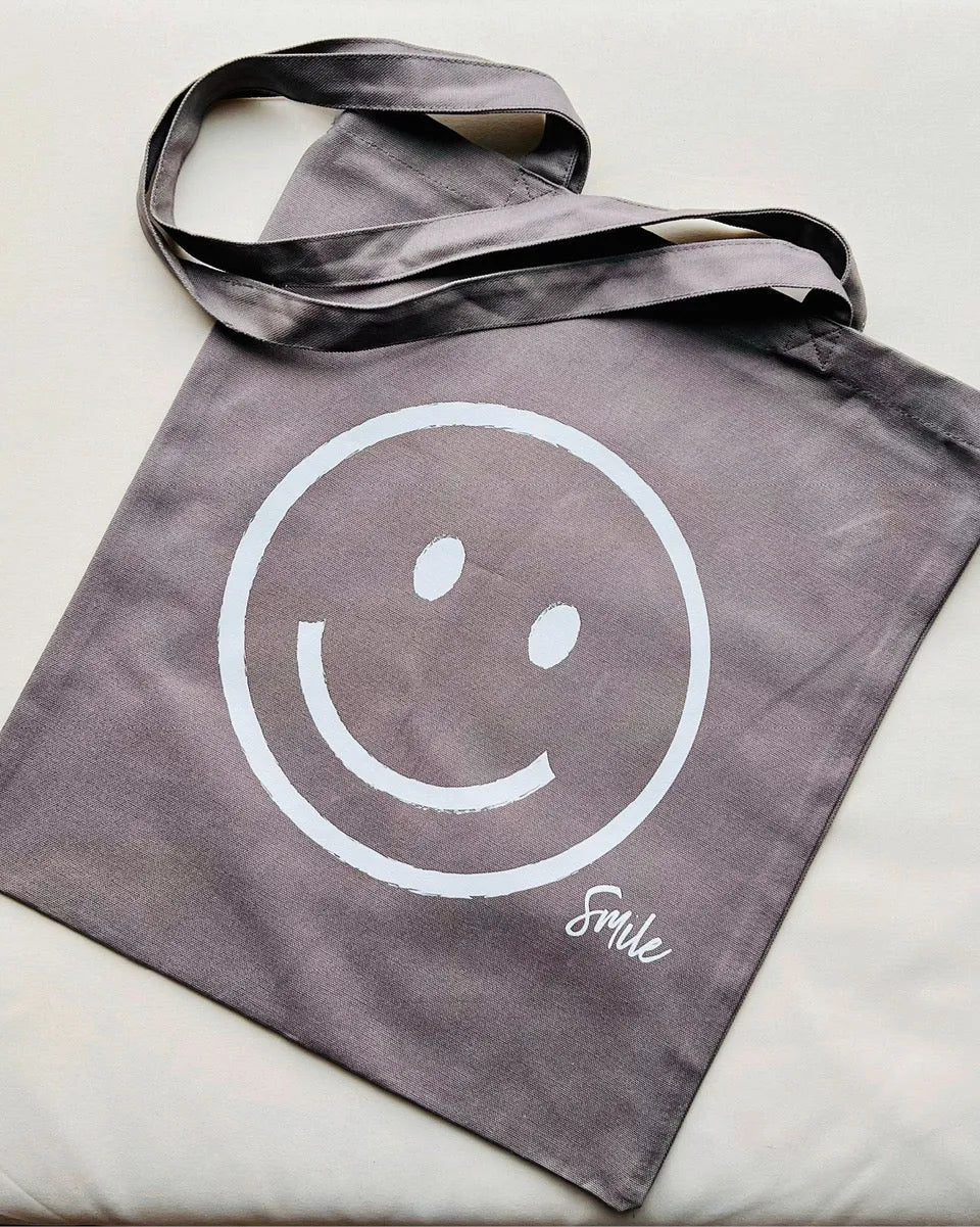 Graue Baumwolltasche mit großem Smiley-Print und Tragegriffen, nachhaltige Stofftasche